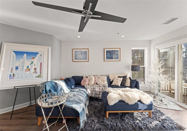 living room with a ceiling fan, wood finished floors, visible vents, and recessed lighting