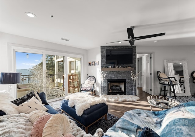 living area featuring recessed lighting, visible vents, a large fireplace, ceiling fan, and wood finished floors