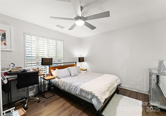 bedroom featuring baseboards, visible vents, ceiling fan, and wood finished floors