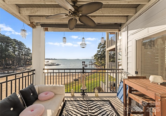 balcony featuring a water view, a sunroom, and ceiling fan