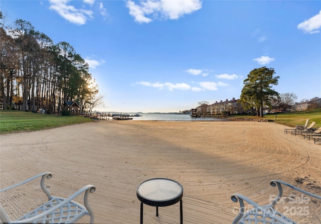 view of property's community featuring a beach view and a water view