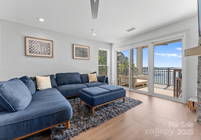 living area featuring recessed lighting, wood finished floors, visible vents, and ceiling fan