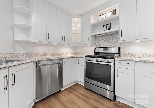 kitchen featuring white cabinets, open shelves, and stainless steel appliances