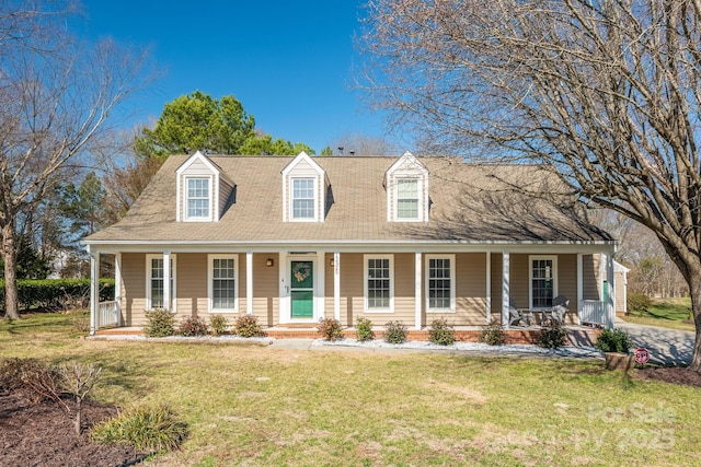 cape cod house with a porch and a front lawn