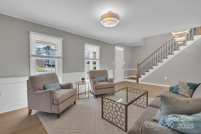 living room with ornamental molding and wood-type flooring