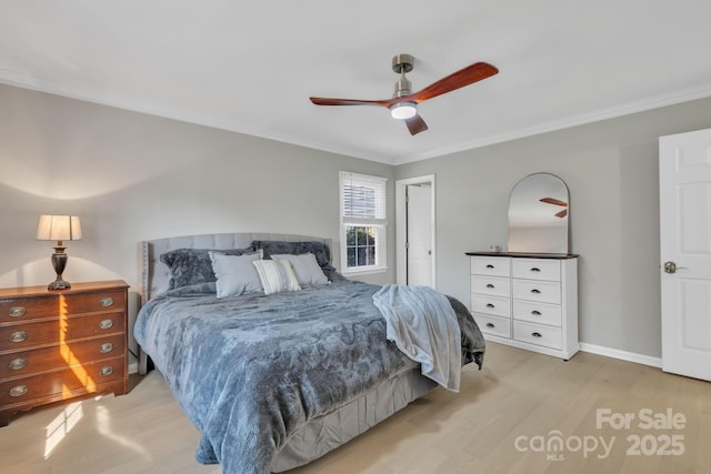 bedroom featuring ornamental molding, light hardwood / wood-style floors, and ceiling fan