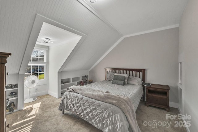 carpeted bedroom with lofted ceiling