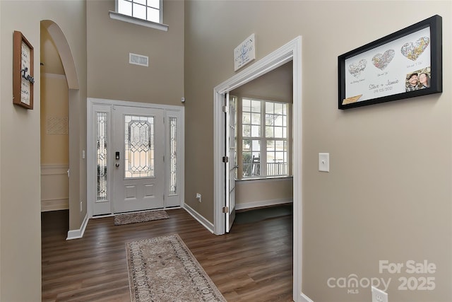 foyer featuring dark hardwood / wood-style flooring and a high ceiling