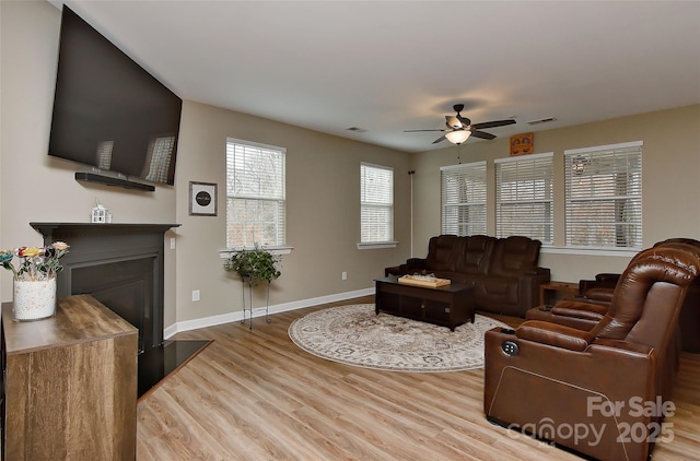 living room with hardwood / wood-style floors and ceiling fan