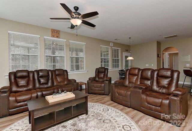 living room featuring ceiling fan and light wood-type flooring