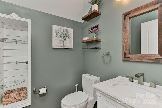 bathroom featuring vanity and toilet