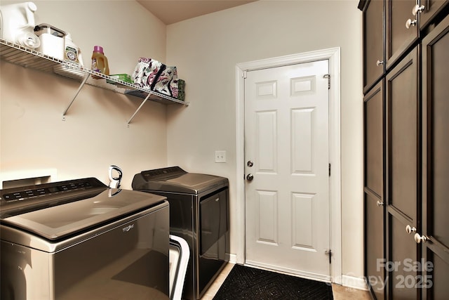 washroom featuring cabinets and washer and dryer