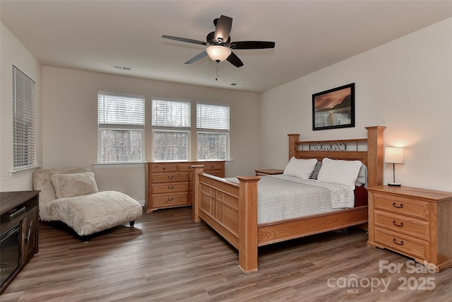 bedroom with wood-type flooring and ceiling fan