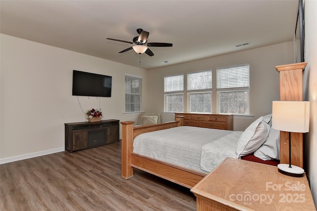 bedroom with ceiling fan and hardwood / wood-style floors