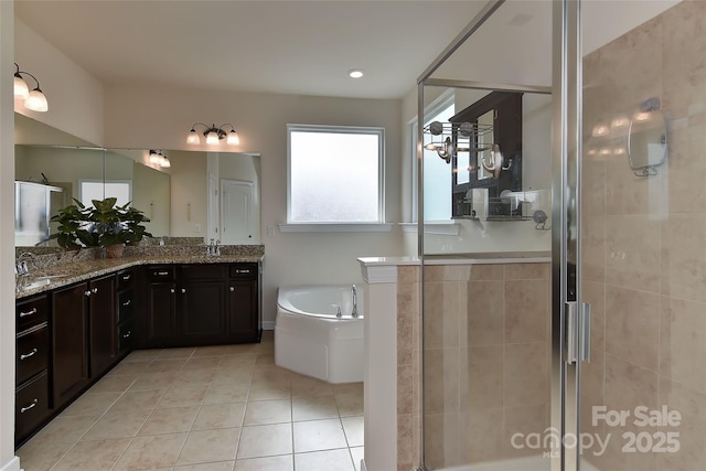 bathroom with tile patterned flooring, vanity, and independent shower and bath