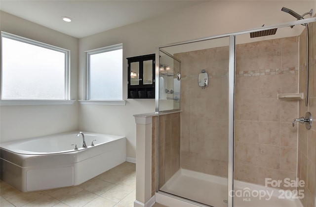 bathroom featuring independent shower and bath and tile patterned flooring