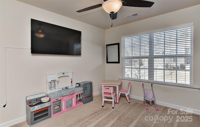 rec room with light colored carpet and ceiling fan