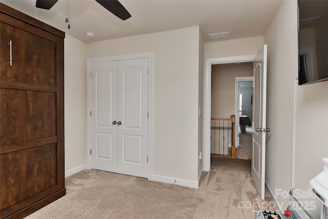 carpeted bedroom with a closet and ceiling fan