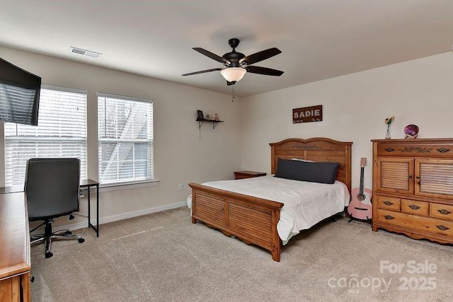 bedroom with ceiling fan and light carpet