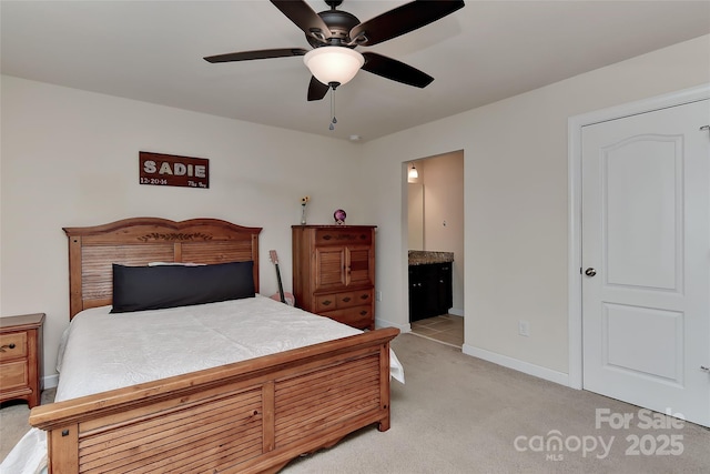 carpeted bedroom with connected bathroom and ceiling fan