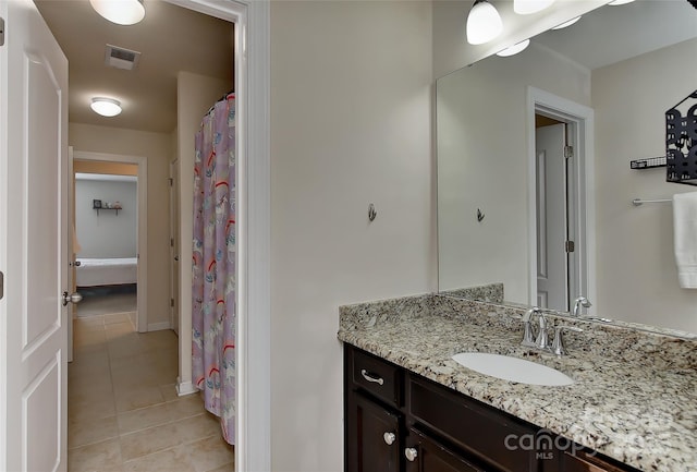 bathroom featuring tile patterned flooring and vanity