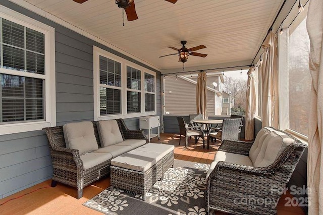 sunroom / solarium featuring wood ceiling and ceiling fan