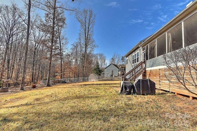 view of yard featuring a sunroom