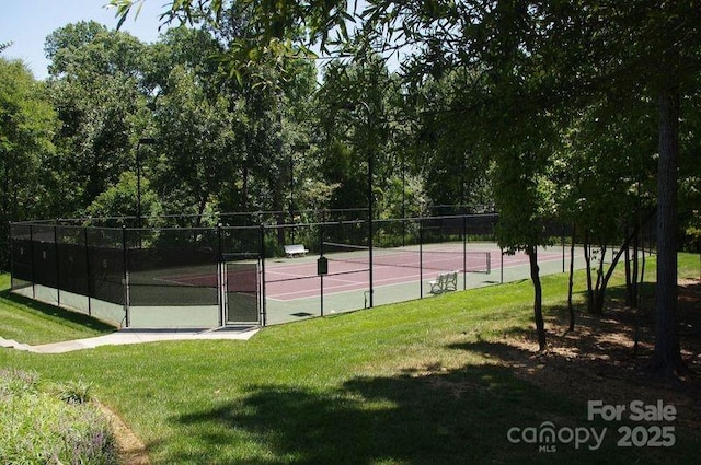 view of sport court with a lawn