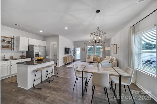 dining space featuring dark hardwood / wood-style floors and sink