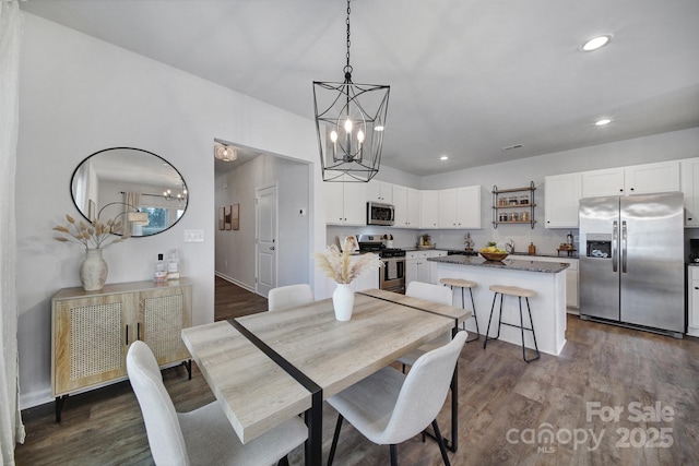 dining room featuring dark hardwood / wood-style flooring and a chandelier