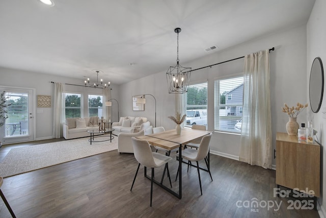 dining room with an inviting chandelier and dark hardwood / wood-style flooring