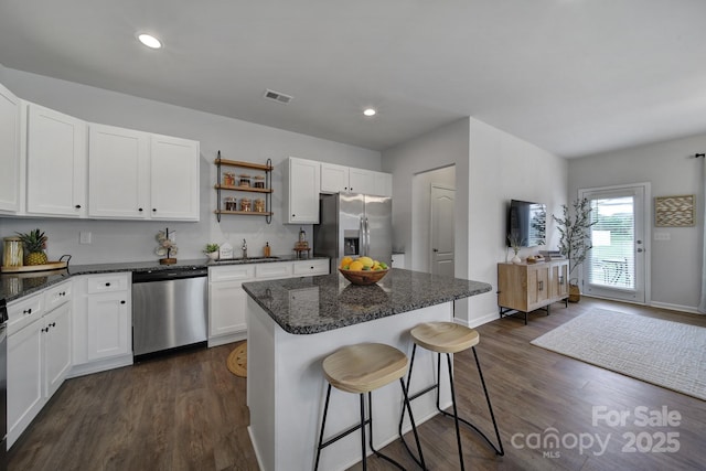 kitchen with sink, a center island, white cabinets, and appliances with stainless steel finishes