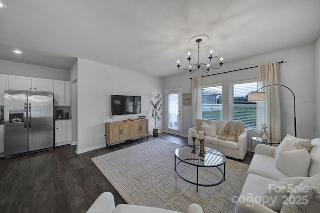 living room featuring dark hardwood / wood-style floors and a chandelier