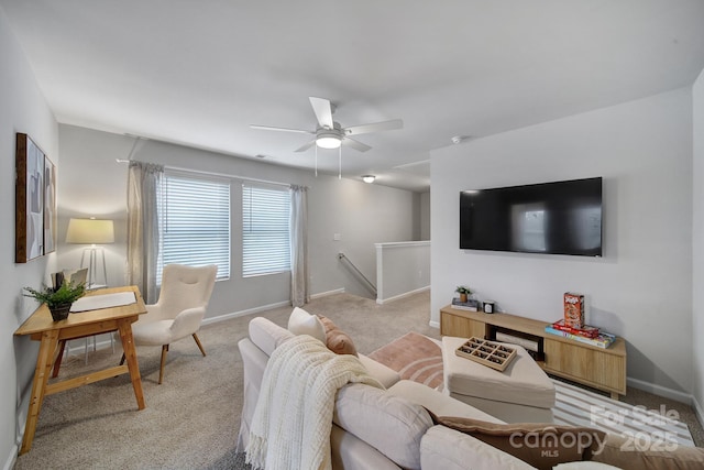 carpeted living room with ceiling fan