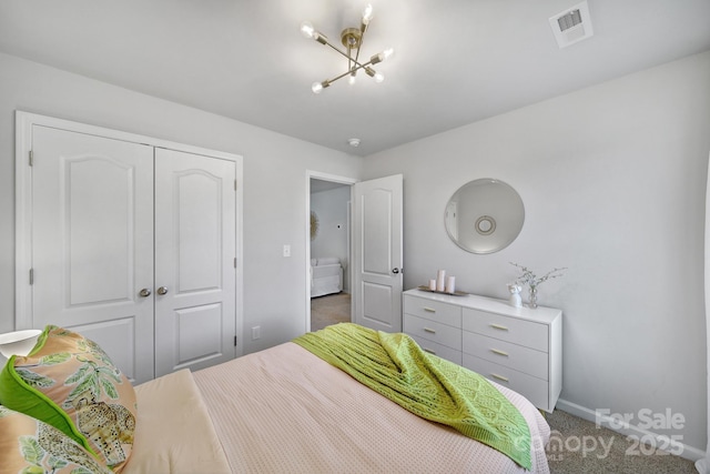 bedroom featuring carpet floors, a chandelier, and a closet