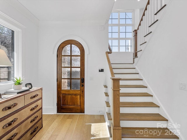 foyer entrance with light hardwood / wood-style floors