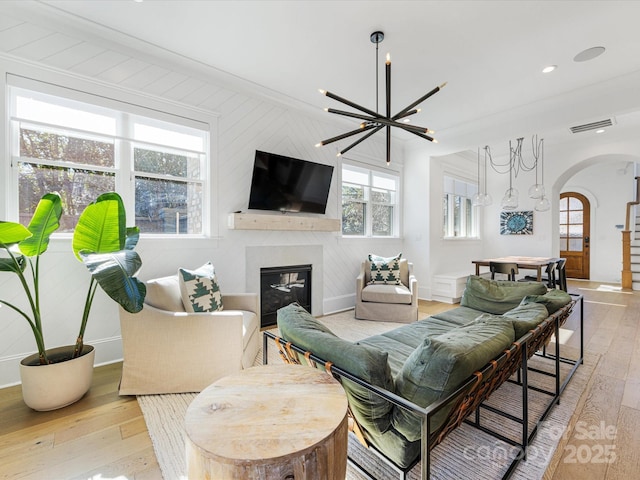 living room featuring light hardwood / wood-style flooring and a notable chandelier