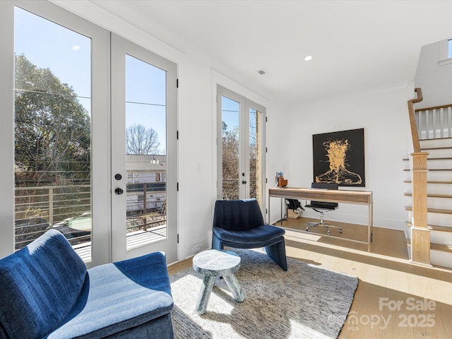 interior space featuring french doors, wood-type flooring, and plenty of natural light