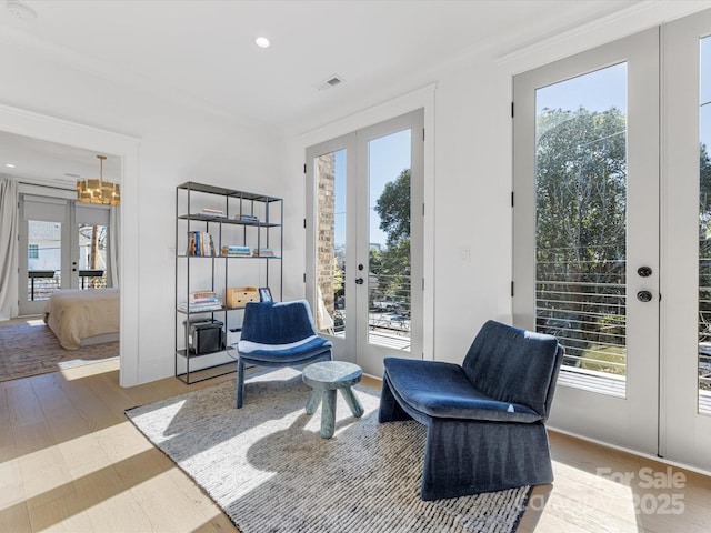 living area with hardwood / wood-style floors and french doors