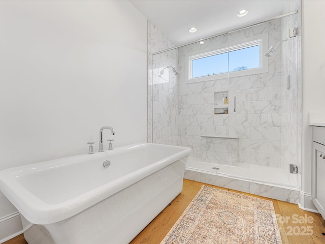 bathroom featuring vanity, hardwood / wood-style floors, and shower with separate bathtub