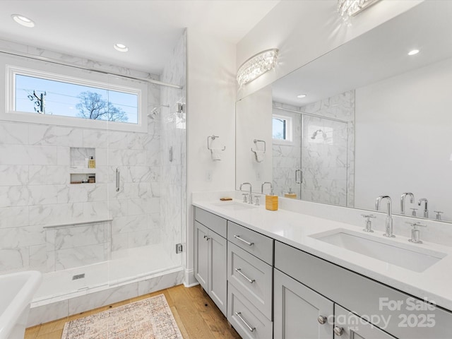 bathroom featuring vanity, an enclosed shower, and hardwood / wood-style floors