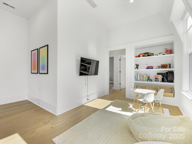 interior space featuring built in features and light hardwood / wood-style flooring