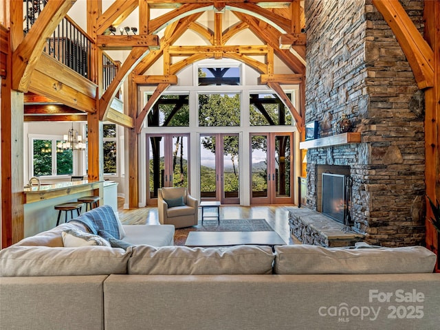 unfurnished living room featuring high vaulted ceiling, plenty of natural light, and a fireplace