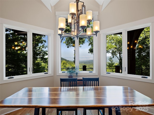 dining area featuring lofted ceiling and a chandelier