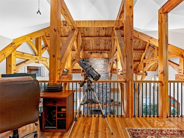 interior space with beam ceiling and wood finished floors