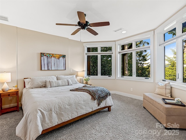 carpeted bedroom with baseboards, visible vents, and ceiling fan