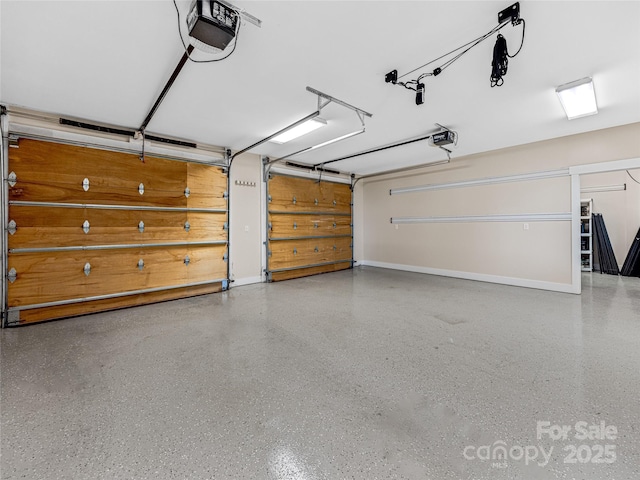 garage featuring baseboards and a garage door opener