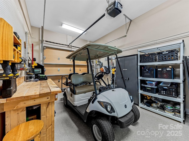 garage featuring a garage door opener and a workshop area