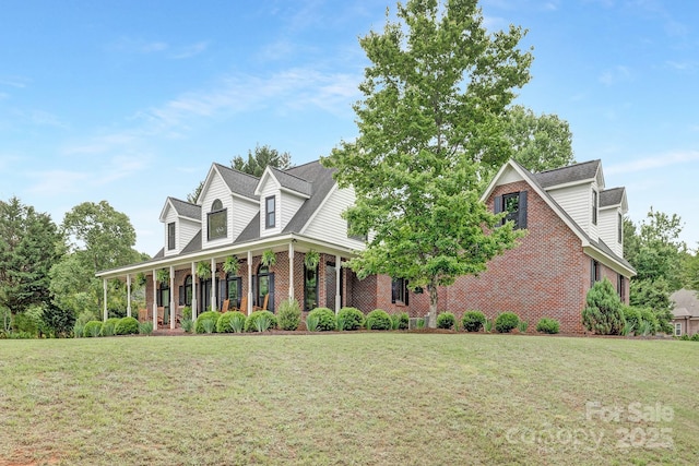 3300 Chancellor Ln, Monroe, NC 28110 - new england style home featuring brick siding, a front lawn, and covered porch