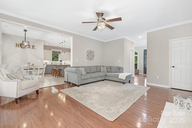 3300 Chancellor Ln, Monroe, NC 28110 - living room with ceiling fan, light wood-type flooring, crown molding, and baseboards